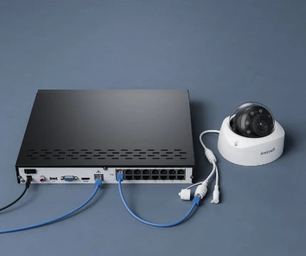 Reolink RLN16-410 black 24-Channel PoE NVR for 24/7 Continuous Recording on grey background. plugged into to power, router and white reolink camera